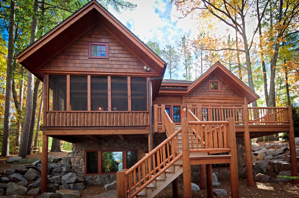 Mid-sized mountain style brown two-story vinyl exterior home photo in Other with a shingle roof