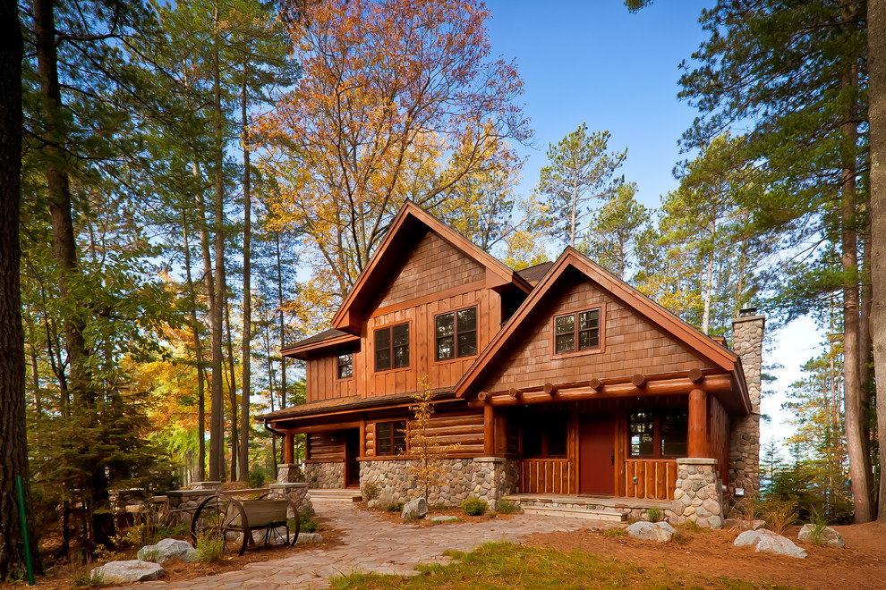 Mid-sized mountain style brown two-story vinyl exterior home photo in Other with a shingle roof