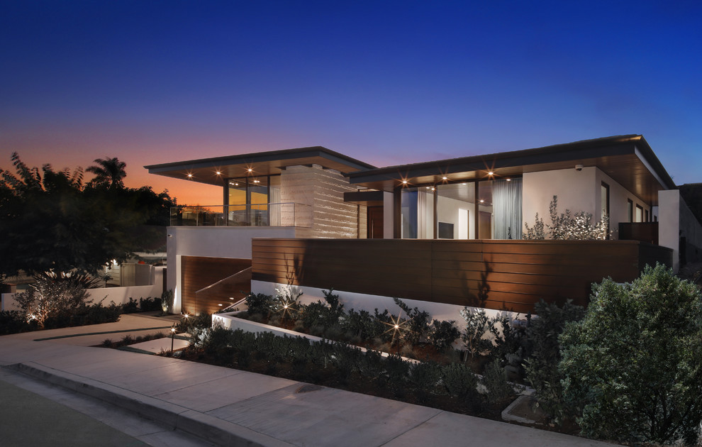 Large trendy beige split-level mixed siding exterior home photo in Los Angeles with a mixed material roof