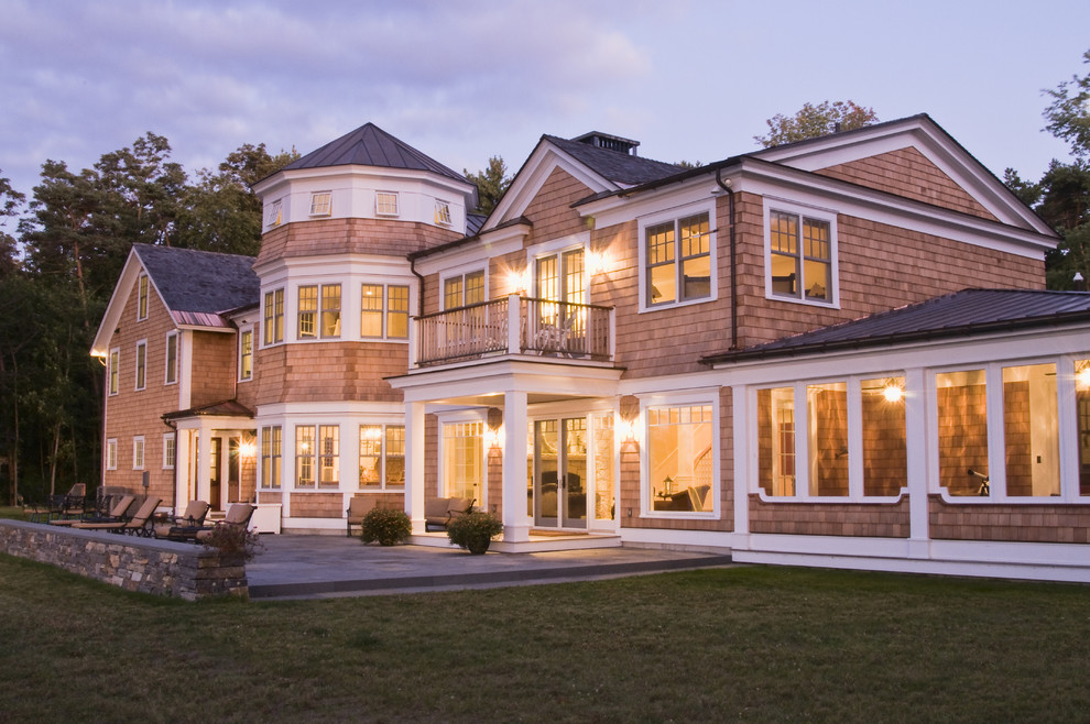 Example of a large ornate beige two-story wood house exterior design in Burlington with a mixed material roof