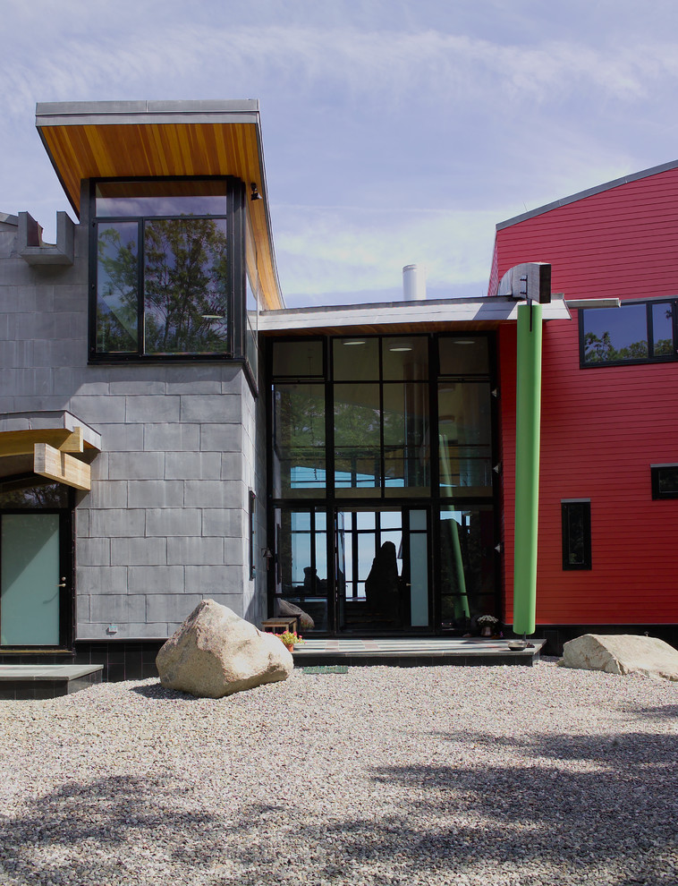 Photo of a large and multi-coloured contemporary two floor detached house in Manchester with metal cladding.