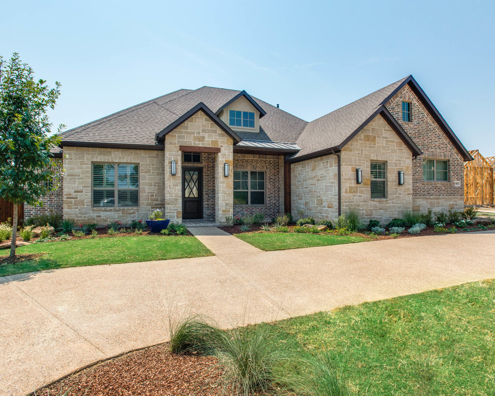 Design ideas for a medium sized and beige traditional bungalow house exterior in Dallas with stone cladding.