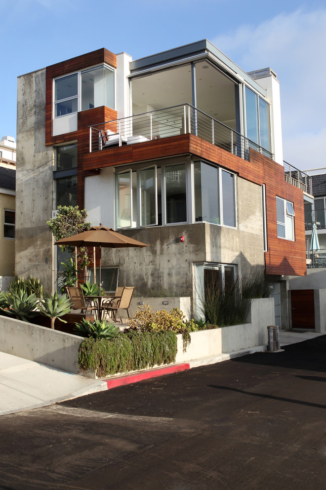 Large minimalist multicolored three-story concrete exterior home photo in Los Angeles
