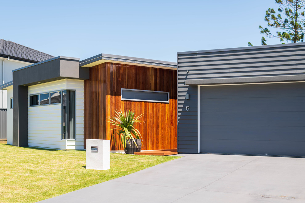 Example of a trendy gray one-story mixed siding exterior home design in Brisbane