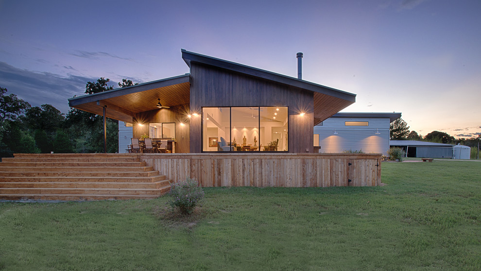 Contemporary bungalow house exterior in Austin with wood cladding and a lean-to roof.