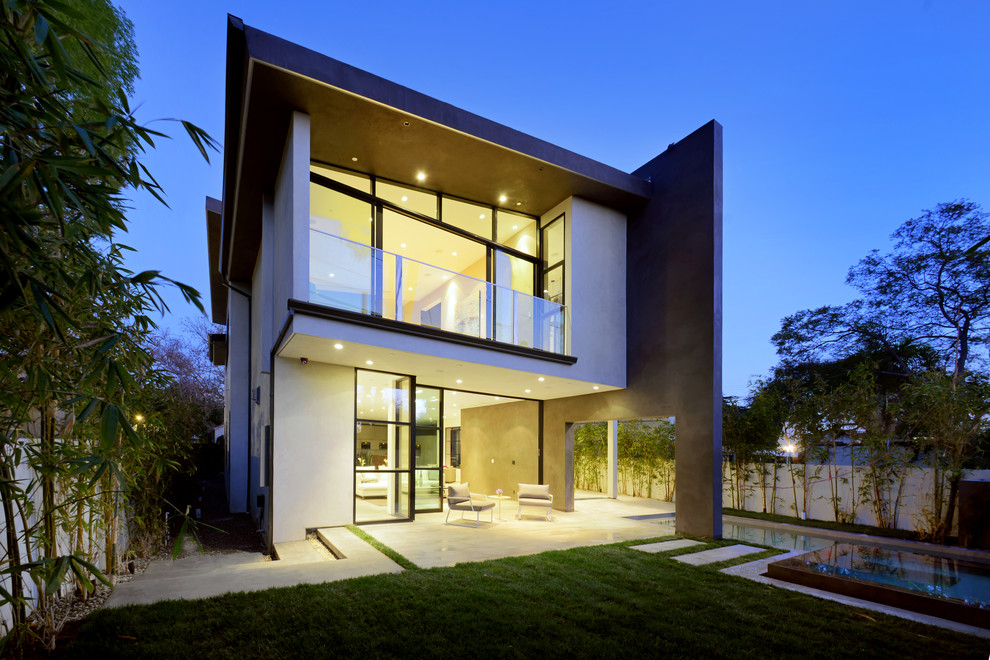 Inspiration for a large contemporary gray two-story stone flat roof remodel in Los Angeles