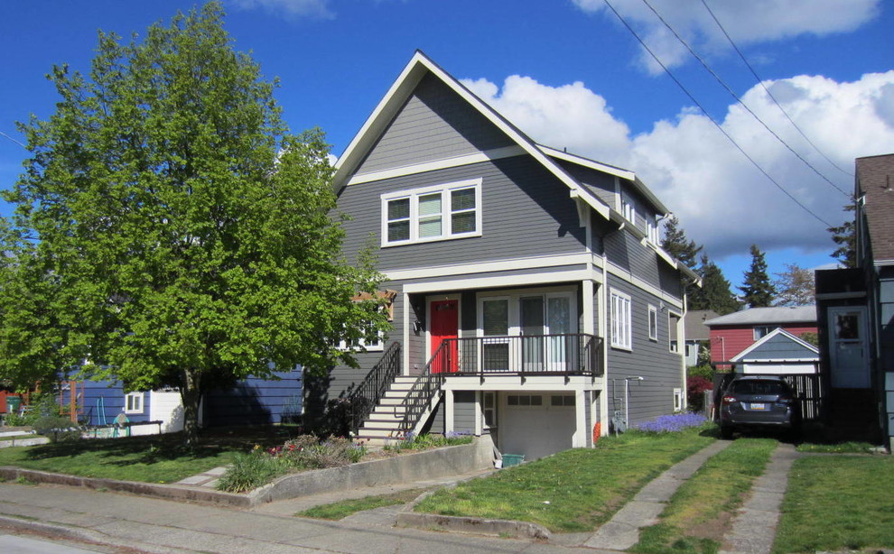 Example of a mid-sized arts and crafts gray two-story concrete fiberboard exterior home design in Seattle