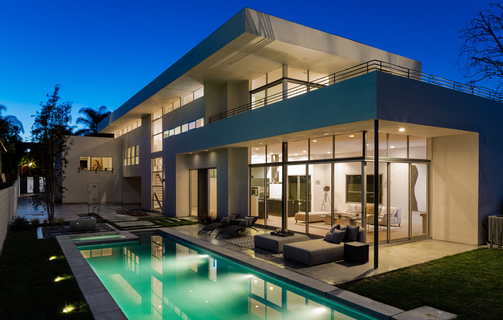 Inspiration for a large modern white two-story stucco flat roof remodel in Los Angeles