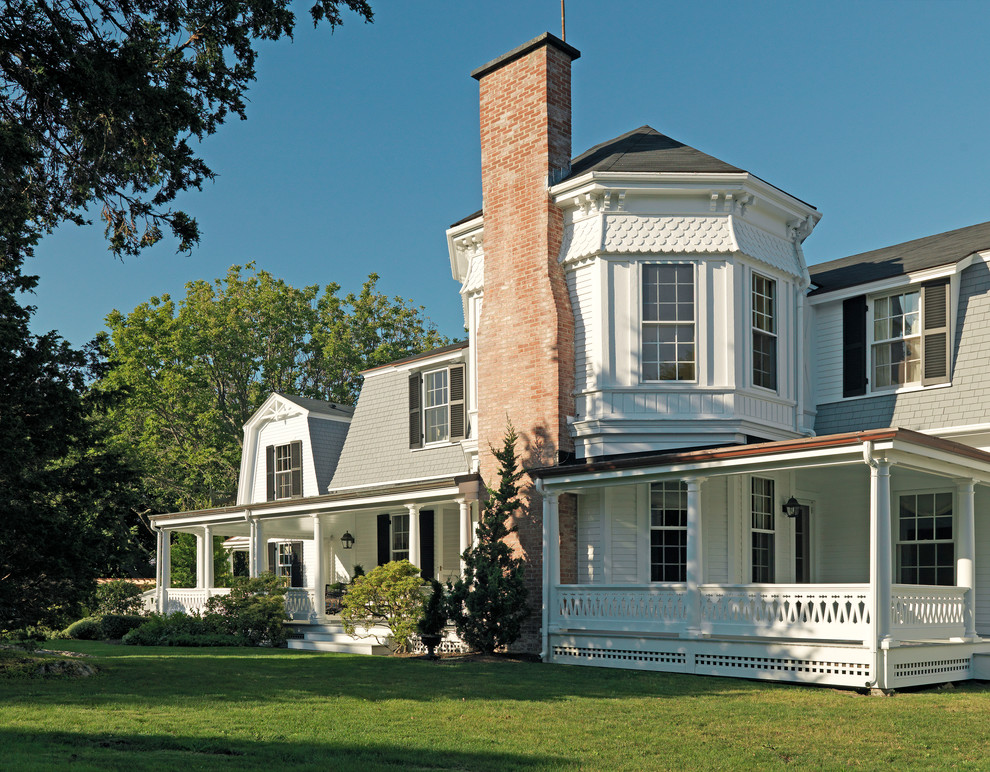 Photo of a white victorian two floor house exterior in Boston with wood cladding.