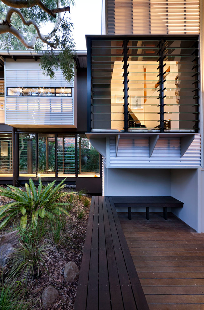 Inspiration for a world-inspired two floor house exterior in Sunshine Coast with metal cladding.