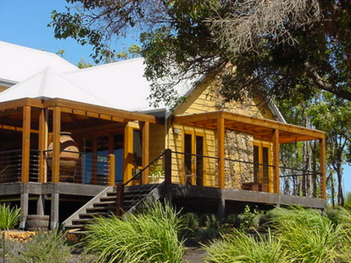 Inspiration for a brown classic two floor house exterior in Perth with wood cladding.