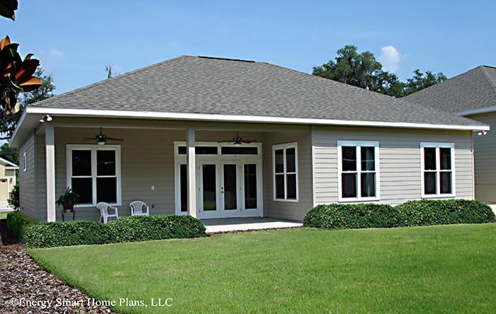 Inspiration for a small and beige classic bungalow house exterior in Tampa with vinyl cladding.