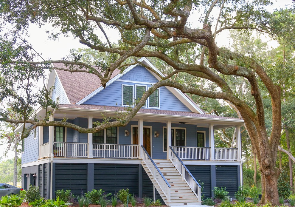 This is an example of a medium sized classic two floor concrete house exterior in Charleston.