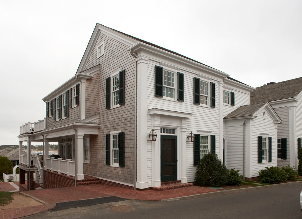 Medium sized and white coastal two floor house exterior in New York with mixed cladding and a pitched roof.