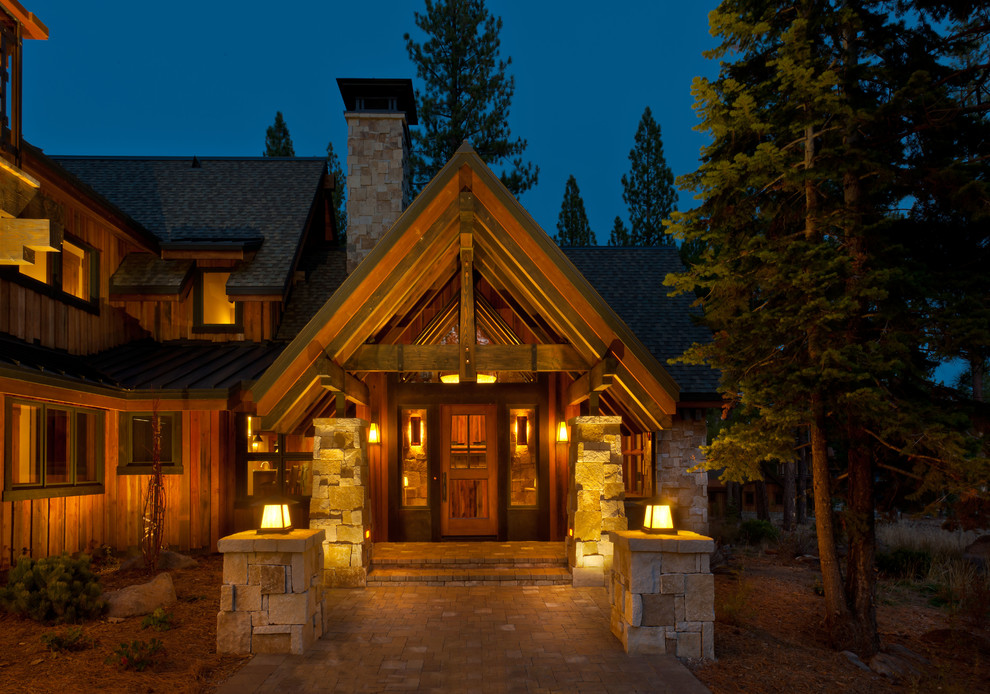 Inspiration for a huge rustic brown two-story wood exterior home remodel in Sacramento with a mixed material roof