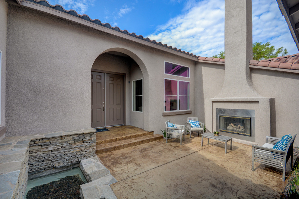 Mid-sized transitional beige one-story house exterior photo in Las Vegas with a tile roof