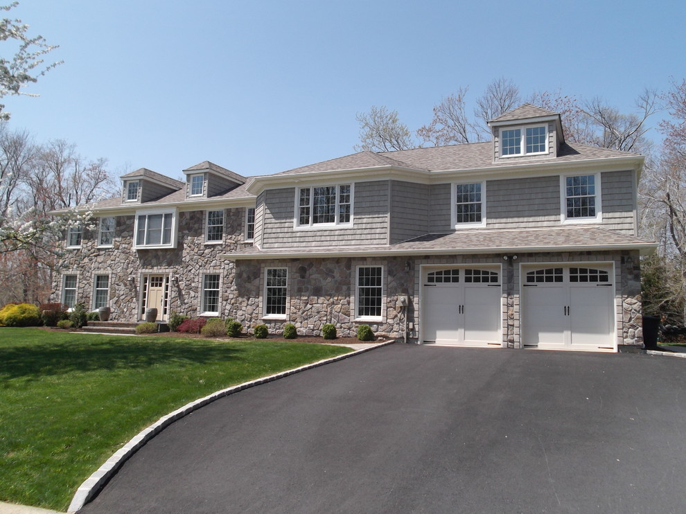 Inspiration for a large timeless gray two-story mixed siding gable roof remodel in Newark