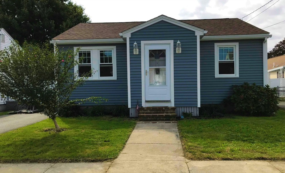 Small and blue classic bungalow detached house in Boston with vinyl cladding, a pitched roof and a shingle roof.