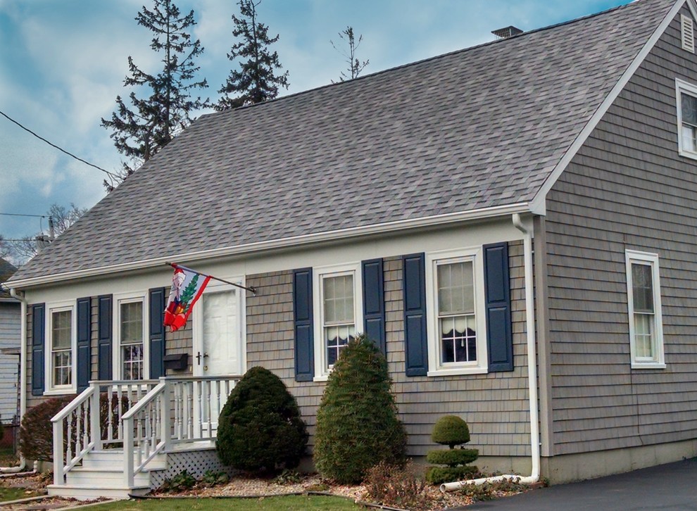 Example of a mid-sized transitional gray vinyl exterior home design in Providence