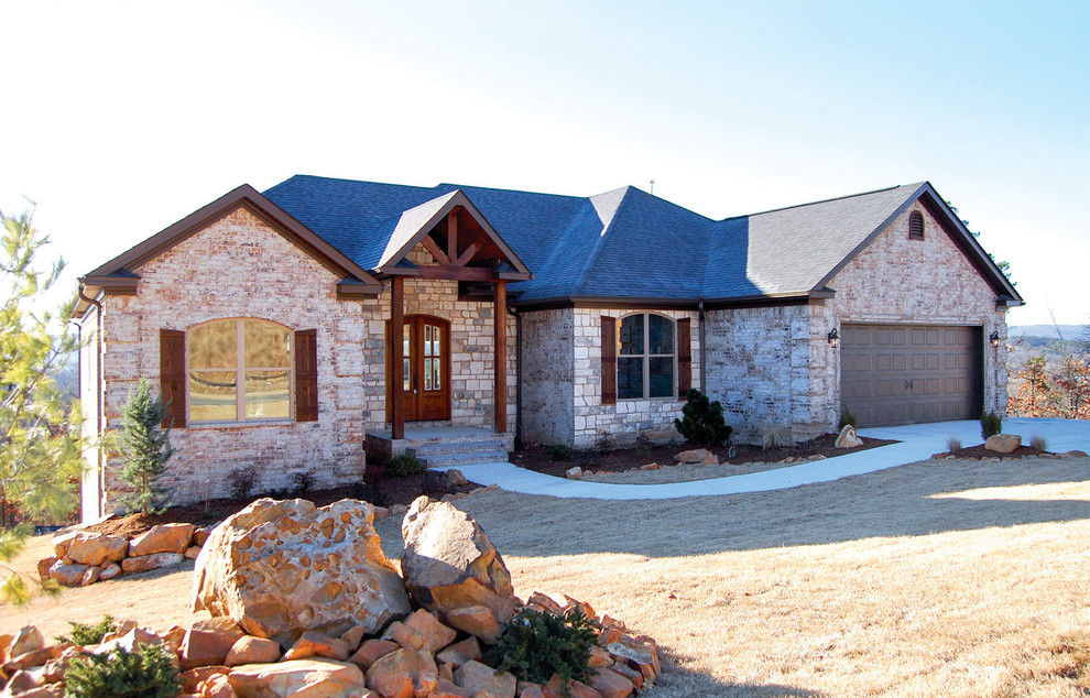 Example of a mid-sized mountain style one-story mixed siding exterior home design in Little Rock with a shingle roof