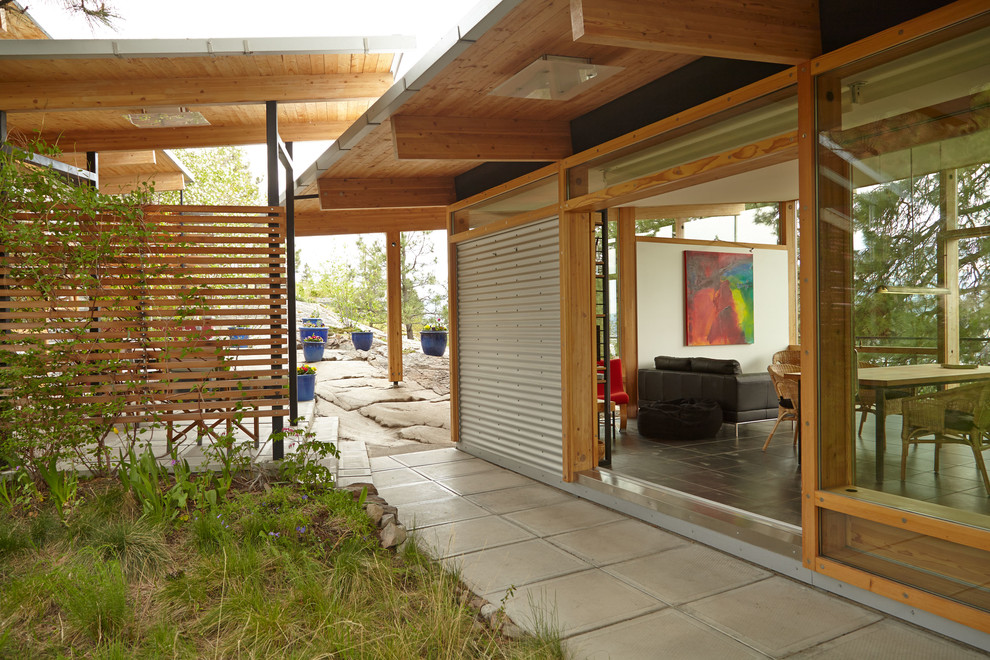 Example of an urban one-story metal exterior home design in Vancouver