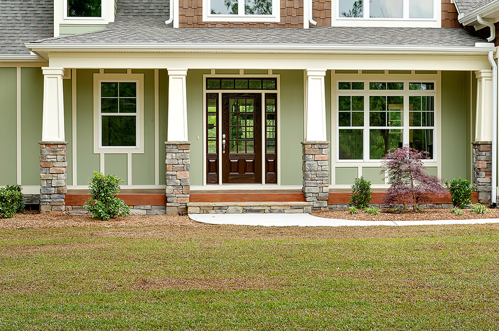 Photo of a green classic two floor house exterior in Other.