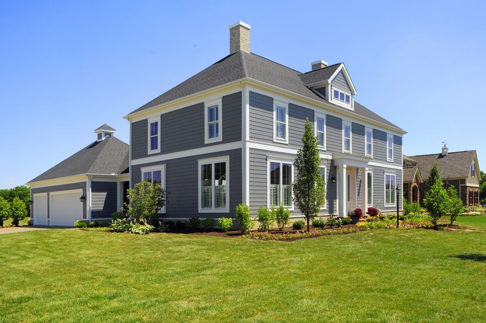 Beach style gray two-story clapboard house exterior photo in Columbus with a hip roof, a shingle roof and a gray roof