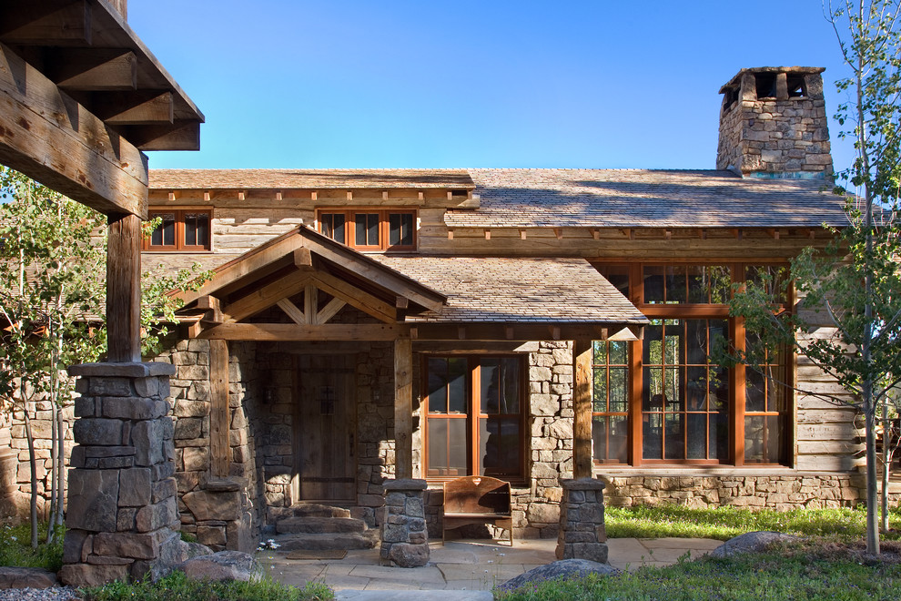 Photo of a rustic house exterior in Other with wood cladding.