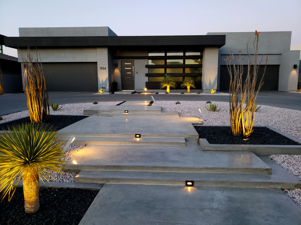 Réalisation d'une très grande façade de maison grise minimaliste en béton à deux étages et plus avec un toit plat.