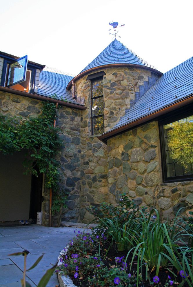 Mid-sized elegant beige two-story stone gable roof photo in Boston