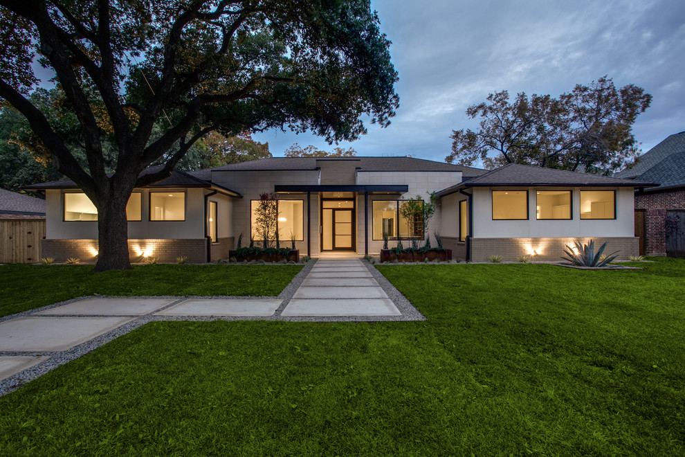 Photo of a white contemporary bungalow house exterior in Dallas.