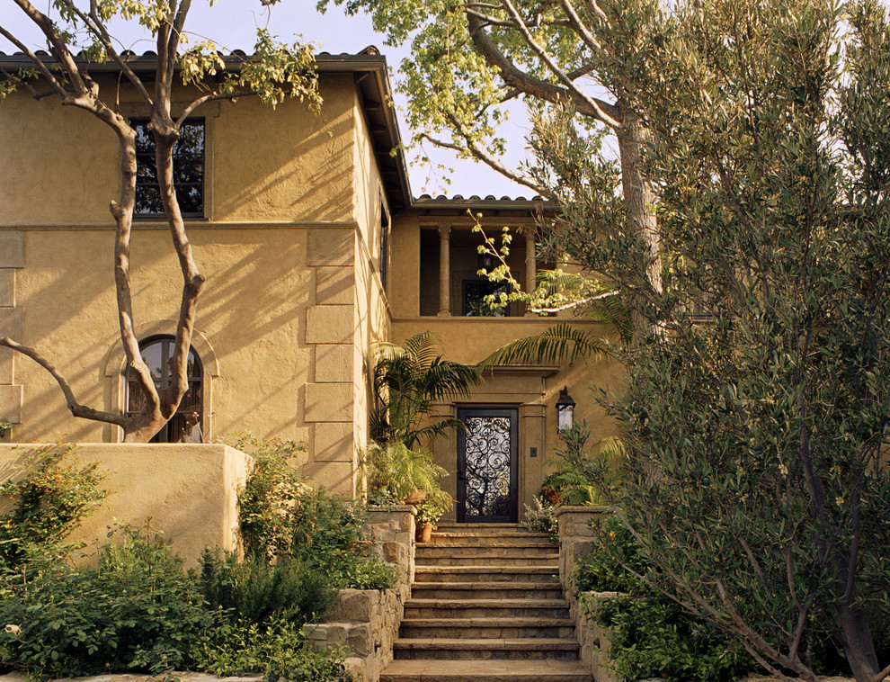 Example of a tuscan two-story exterior home design in Los Angeles