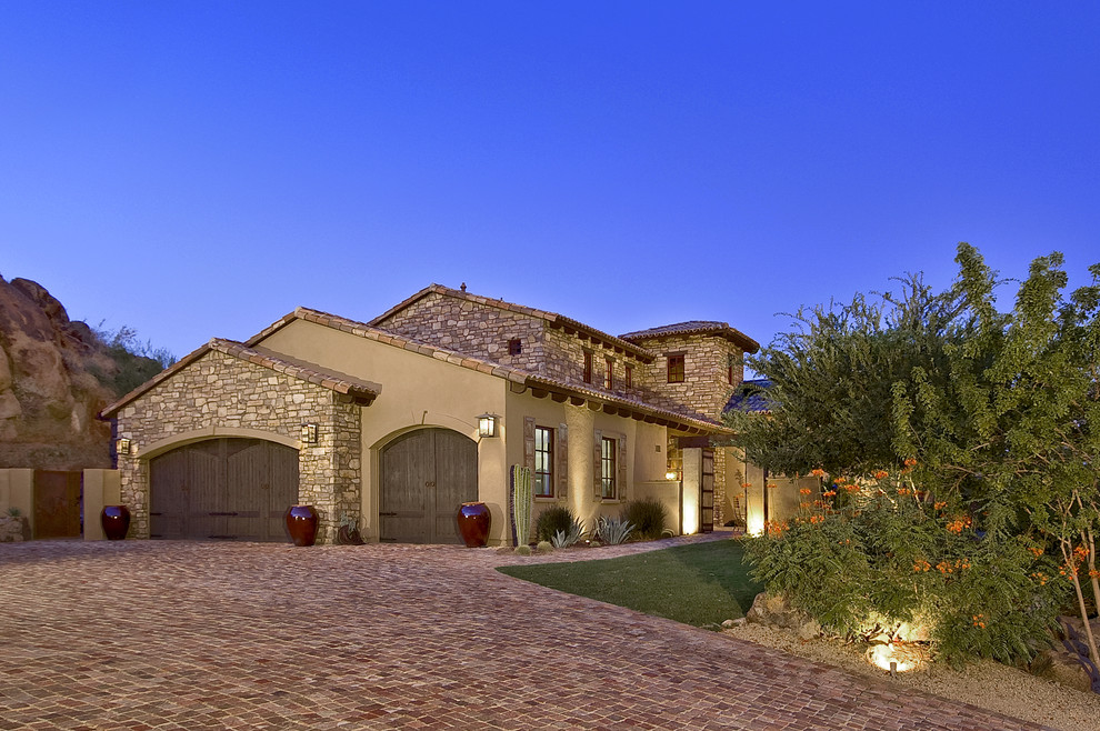 Inspiration for a mediterranean stone exterior home remodel in Phoenix