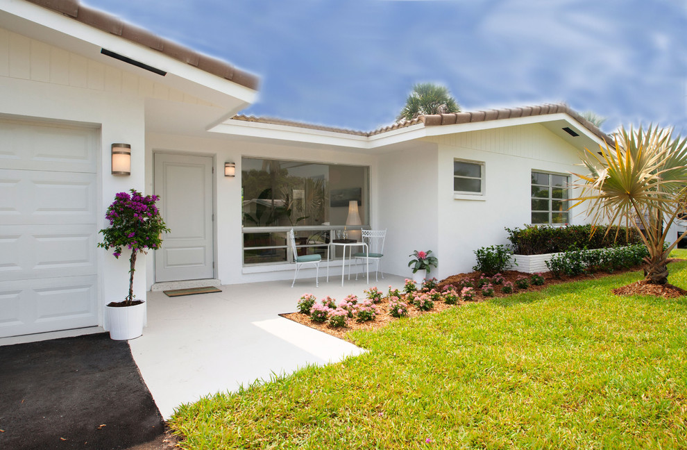 Design ideas for a medium sized and white mediterranean bungalow render house exterior in Miami.