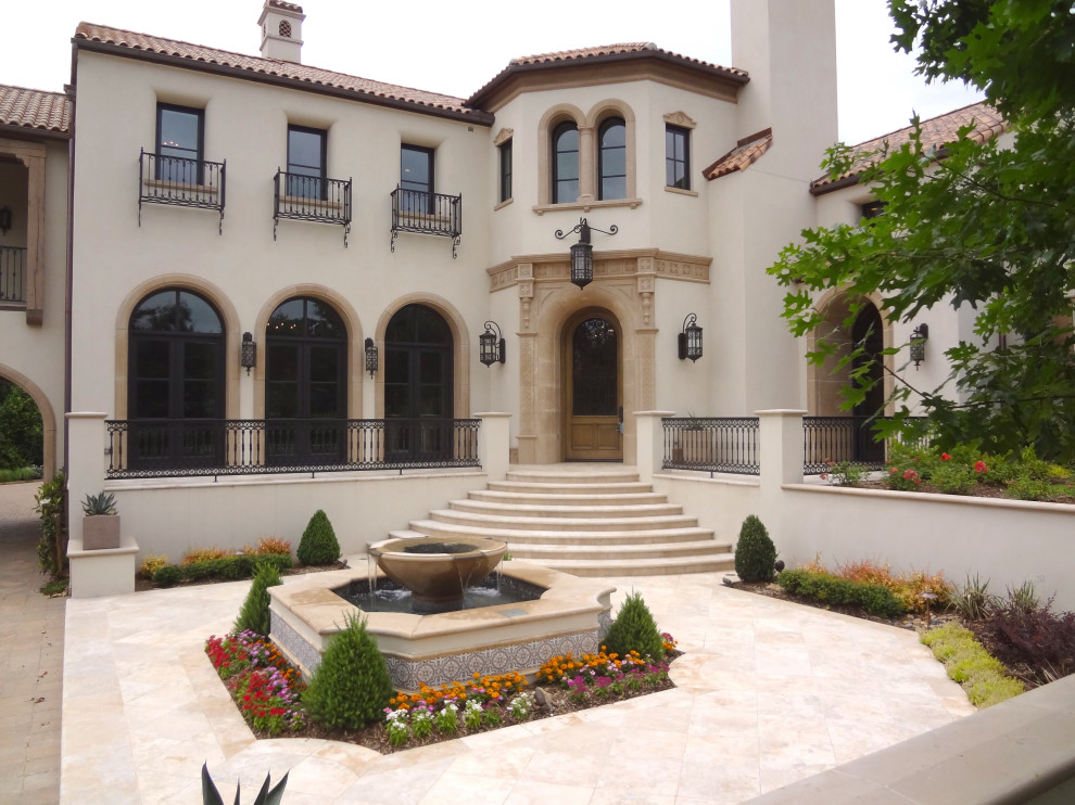Design ideas for an expansive and beige mediterranean two floor detached house in Dallas.