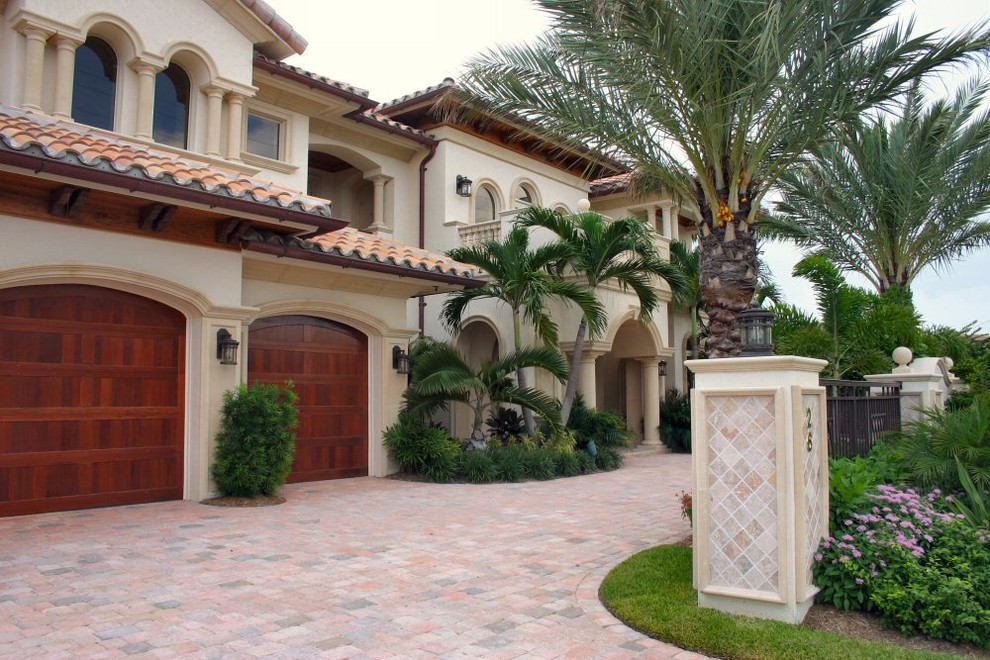 Inspiration for a large mediterranean beige two-story stucco exterior home remodel in Miami