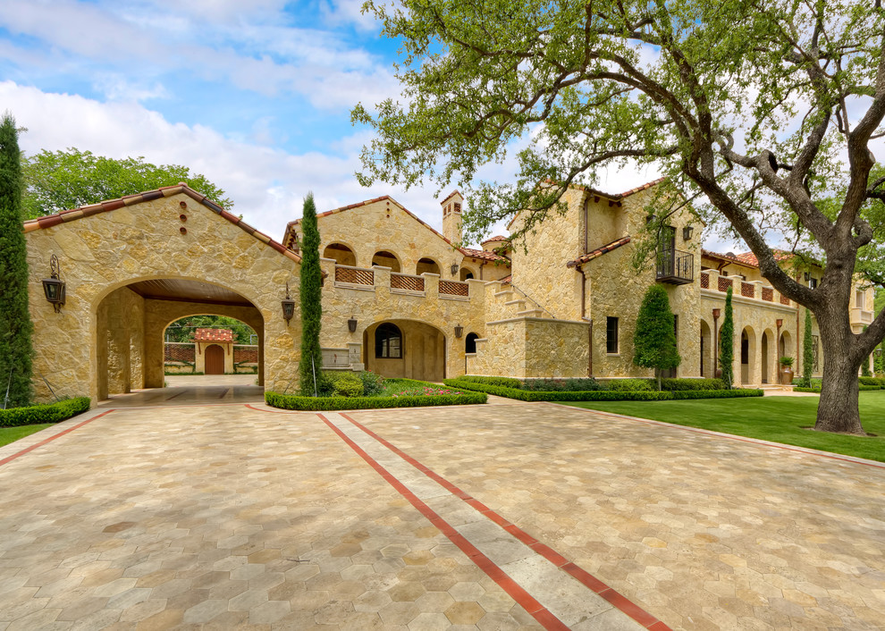 Design ideas for a mediterranean house exterior in Dallas with stone cladding.