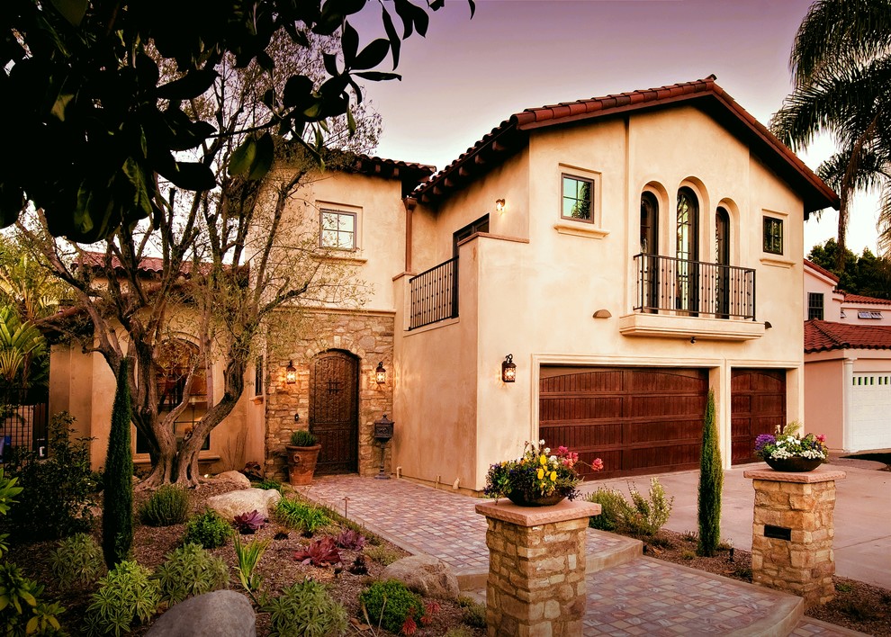 Inspiration for a mediterranean two-story stucco exterior home remodel in Los Angeles