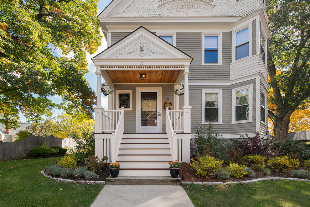 This is an example of a medium sized and gey victorian house exterior in Boston with three floors.