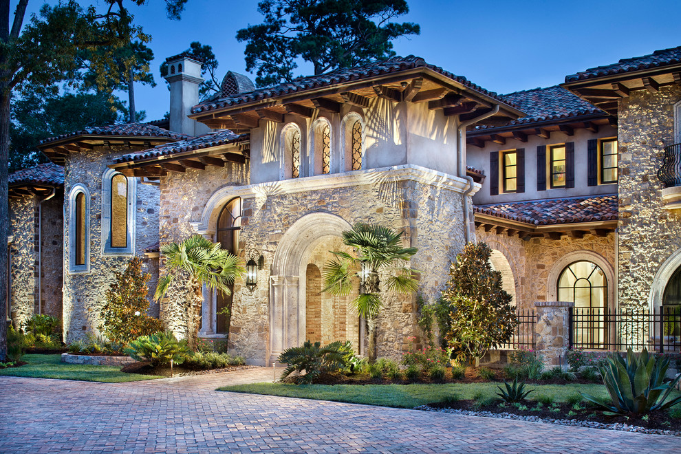 Design ideas for an expansive and beige mediterranean house exterior in Houston with three floors and mixed cladding.