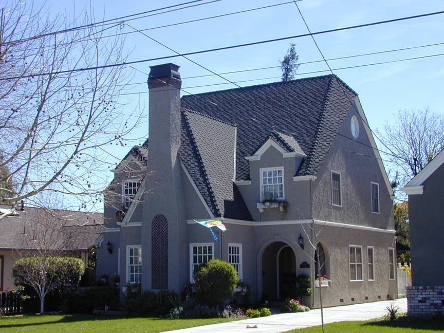 Inspiration for a large timeless gray two-story stucco exterior home remodel in San Francisco with a gambrel roof
