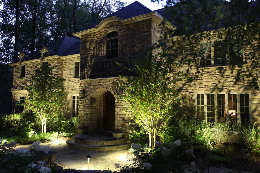 Large traditional beige two-story stone house exterior idea in Newark with a hip roof and a shingle roof