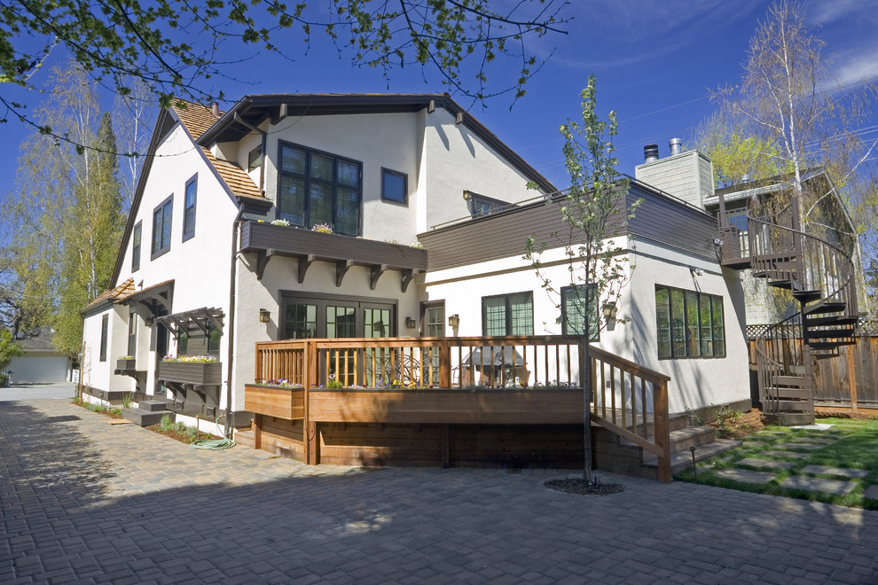 This is an example of a medium sized and white traditional two floor render house exterior in San Francisco with a pitched roof.