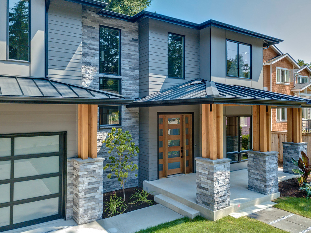 Inspiration for a large contemporary gray two-story house exterior remodel in Seattle with a hip roof and a mixed material roof