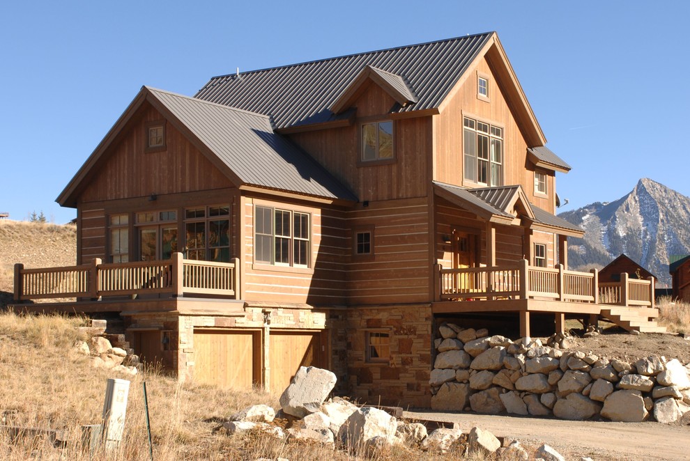 Large and brown rustic detached house in Denver with three floors, wood cladding, a pitched roof and a metal roof.