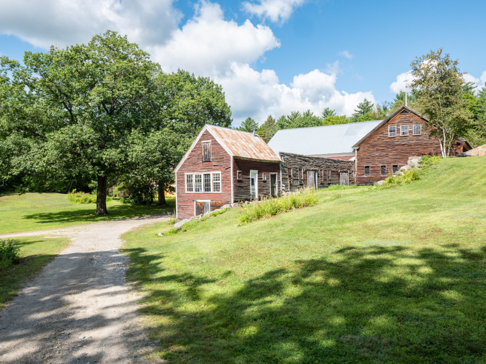 This is an example of an expansive and yellow country detached house in Portland Maine with three floors, wood cladding, a pitched roof and a shingle roof.