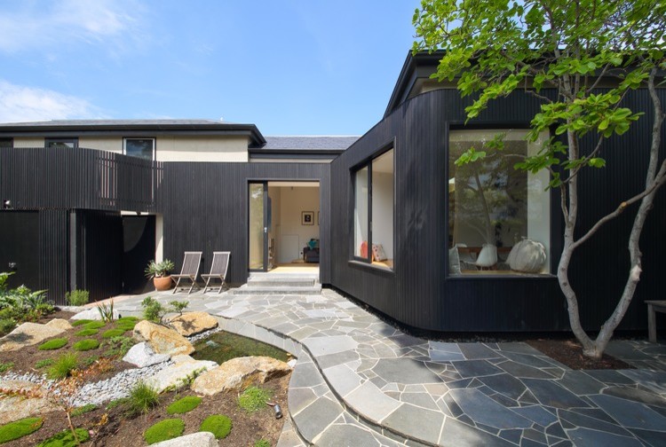Design ideas for a black contemporary bungalow house exterior in Melbourne with wood cladding.