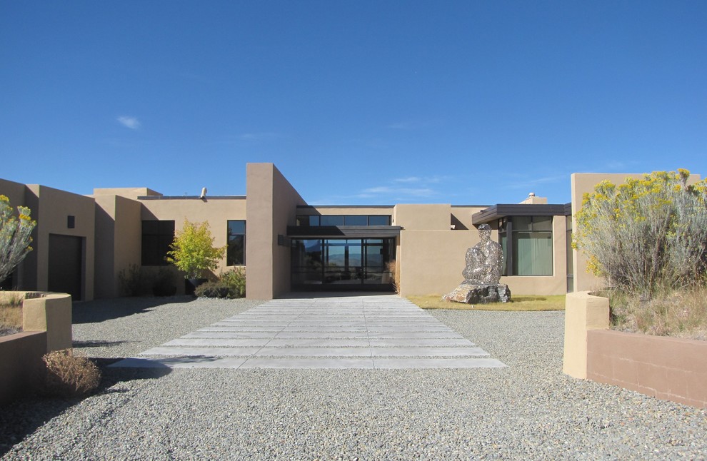 Trendy beige one-story flat roof photo in Albuquerque