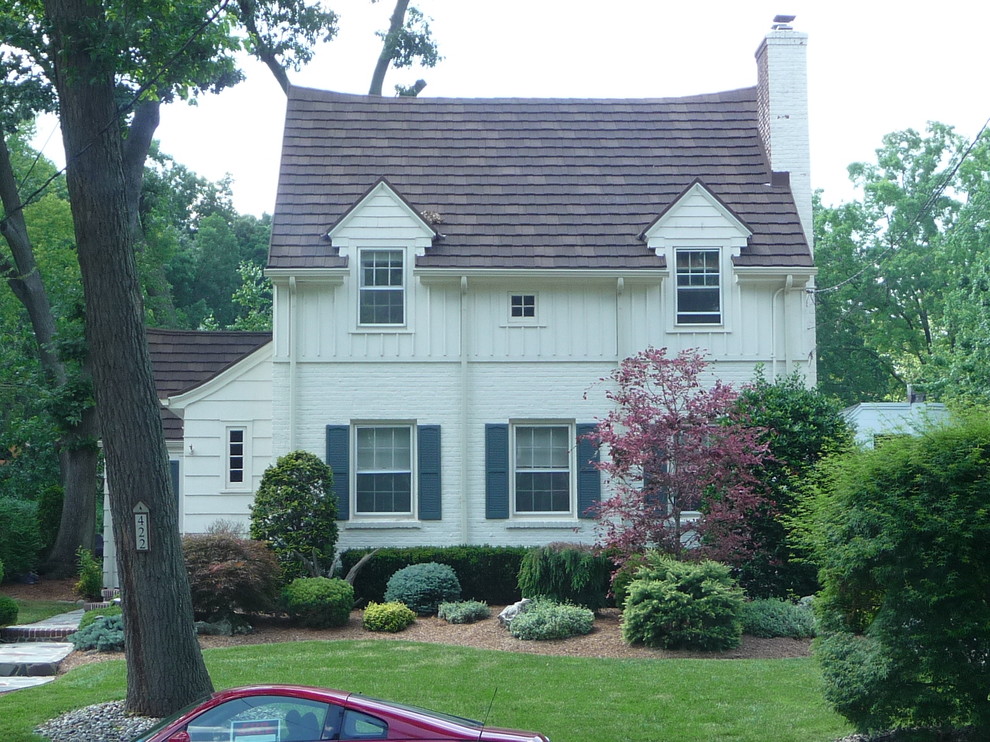 Example of a mid-sized classic white two-story brick exterior home design in Other