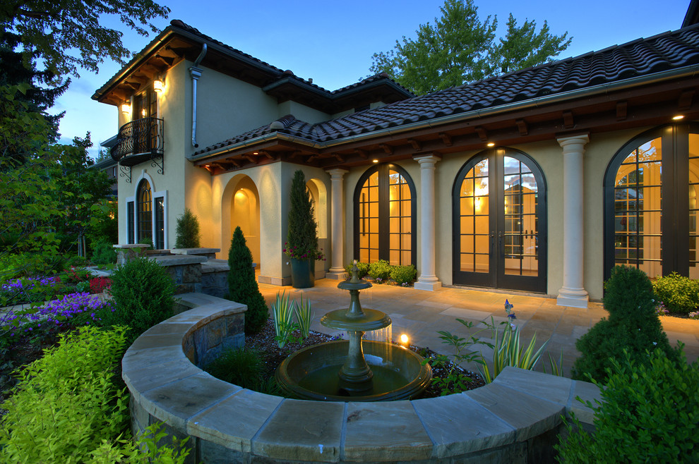Photo of a mediterranean two floor house exterior in Denver.